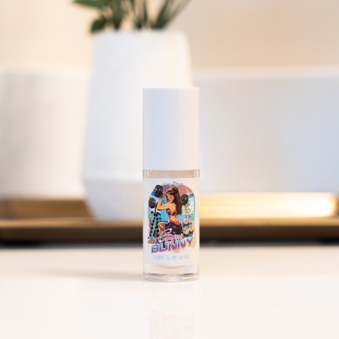 Clear bottle with colorful label featuring a person in a vibrant outfit on a blurred indoor background.