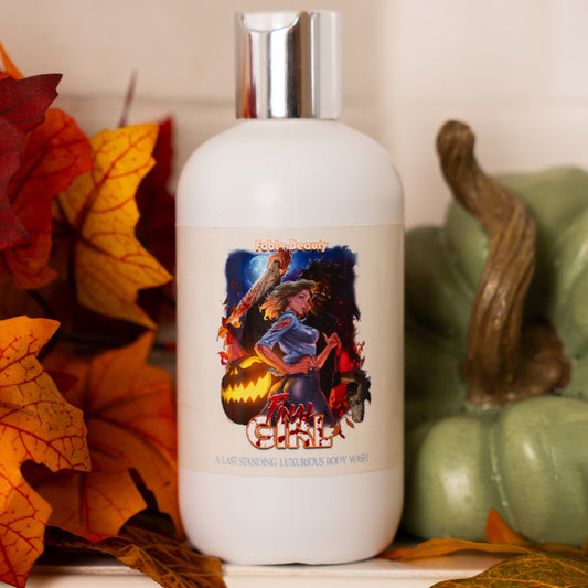 White bottle with a colorful label surrounded by autumn leaves and a green pumpkin.