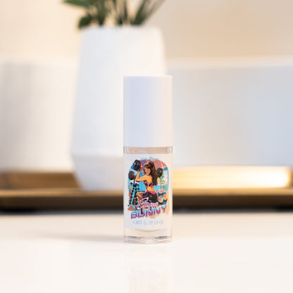 Clear bottle with colorful label featuring a person in a vibrant outfit on a blurred indoor background.