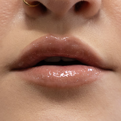 Close-up of a person's lips with a glossy lip product.