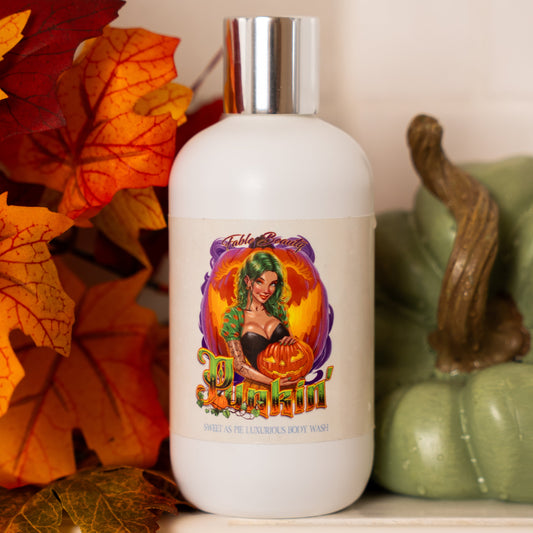 White bottle with a colorful label featuring a woman and pumpkin, surrounded by autumn leaves and a green pumpkin.