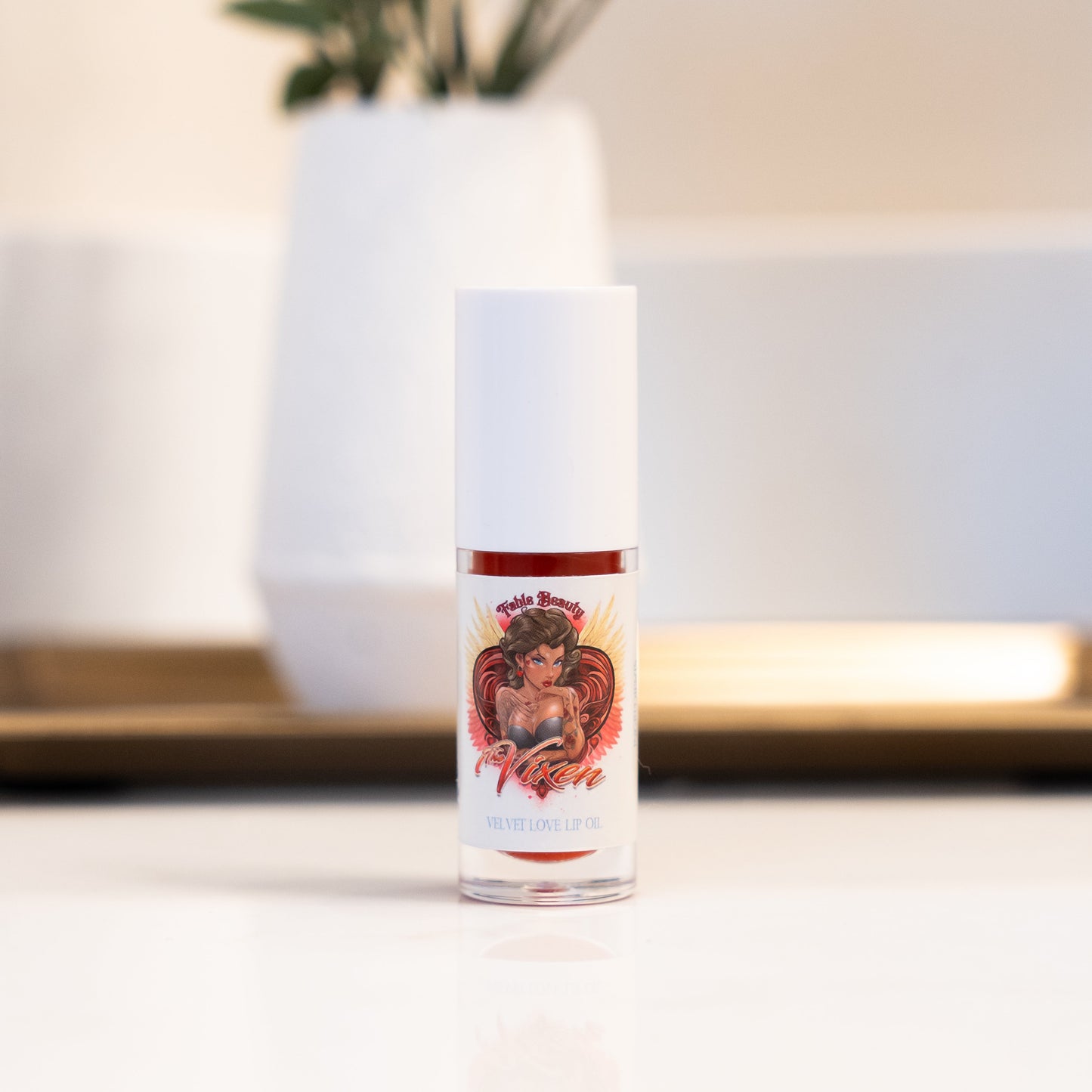 Small bottle with a colorful label featuring a graphic design on a neutral background