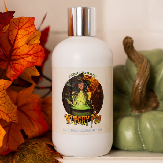 White bottle with a silver cap on a surface with autumn leaves and a green pumpkin.