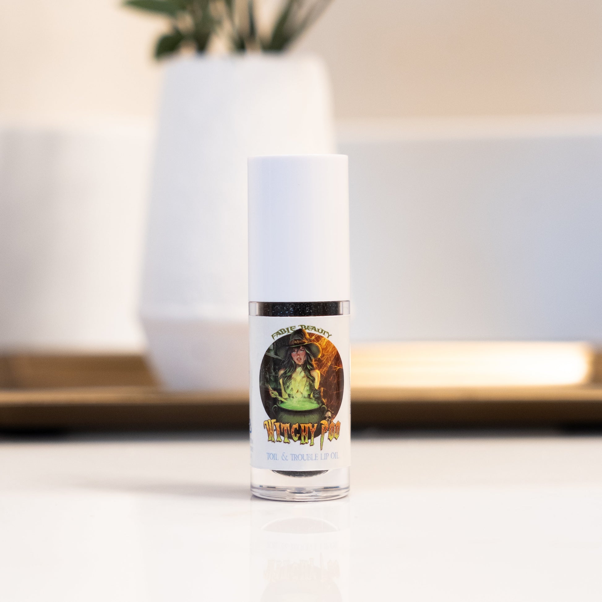 Lotion bottle with label featuring a person in a green dress on a blurred background